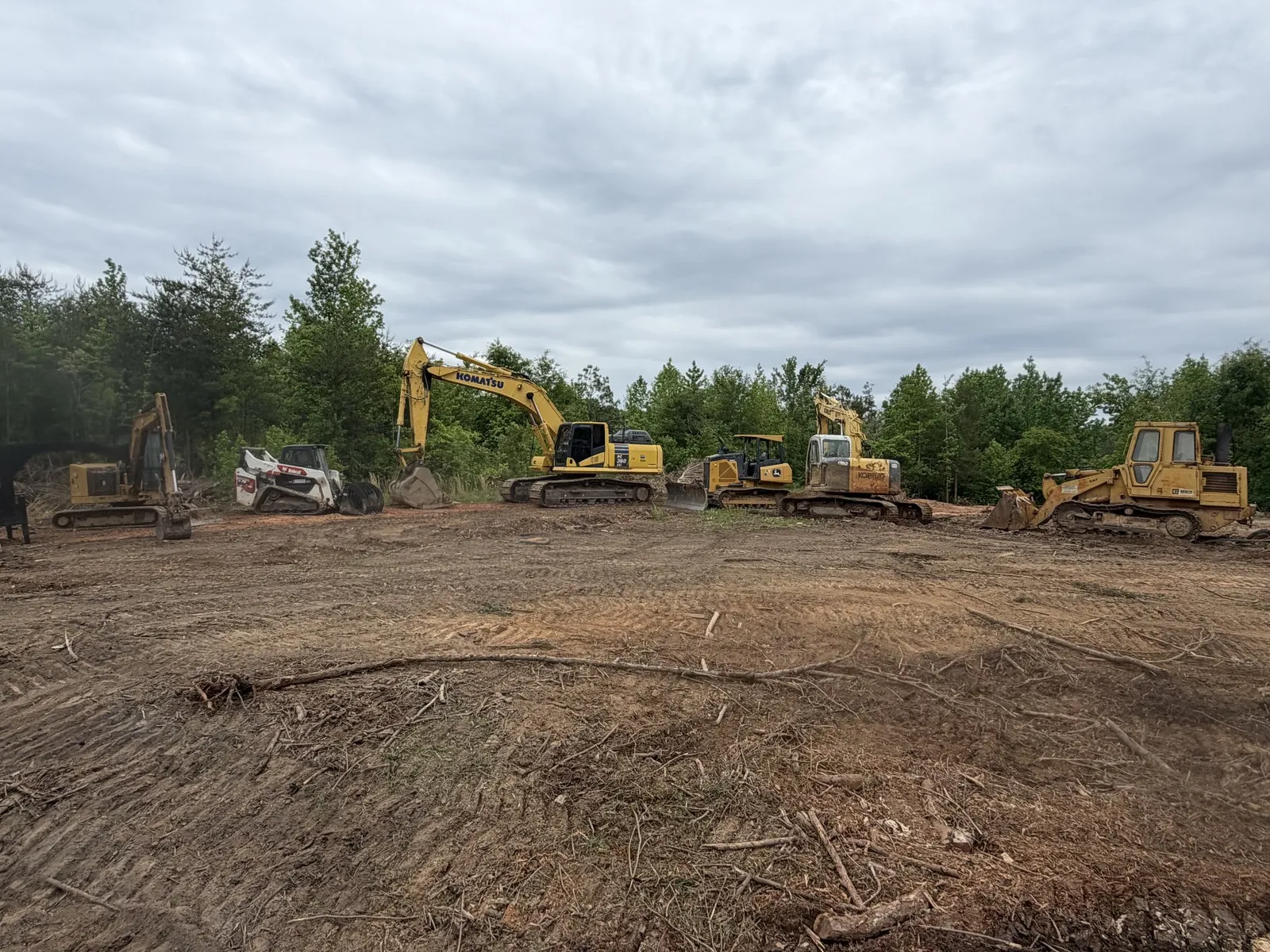 Land clearing crew and excavators working a cleared site in Cleveland County, NC