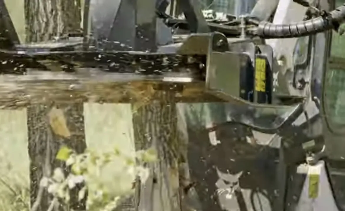 Forestry mulcher head up close with ground brush behind it